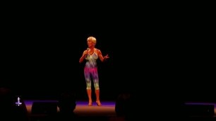 lovely fit septuagenarian woman gives speech at bodybuilding competion