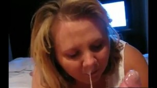 Devoted wife looking the hubby in the eyes while giving a blowjob